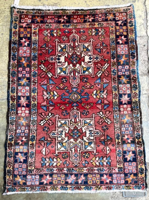 A Heriz red ground rug, 130 x 96cm